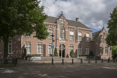 een verouderde foto van het vooraanzicht van ons klooster, er hangen nog oude banieren van de voorgaande uitbater